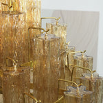 Kester Amber Glass Tier Chandelier | Amber Glass and Brass | Detail shot showing the layered brass frame and hanging glass columns | Severn Lighting