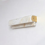 Lamelune Stacked Sconce | Alabaster and Brass | Angled view mounted on grey plaster wall, unlit state | Severn Lighting