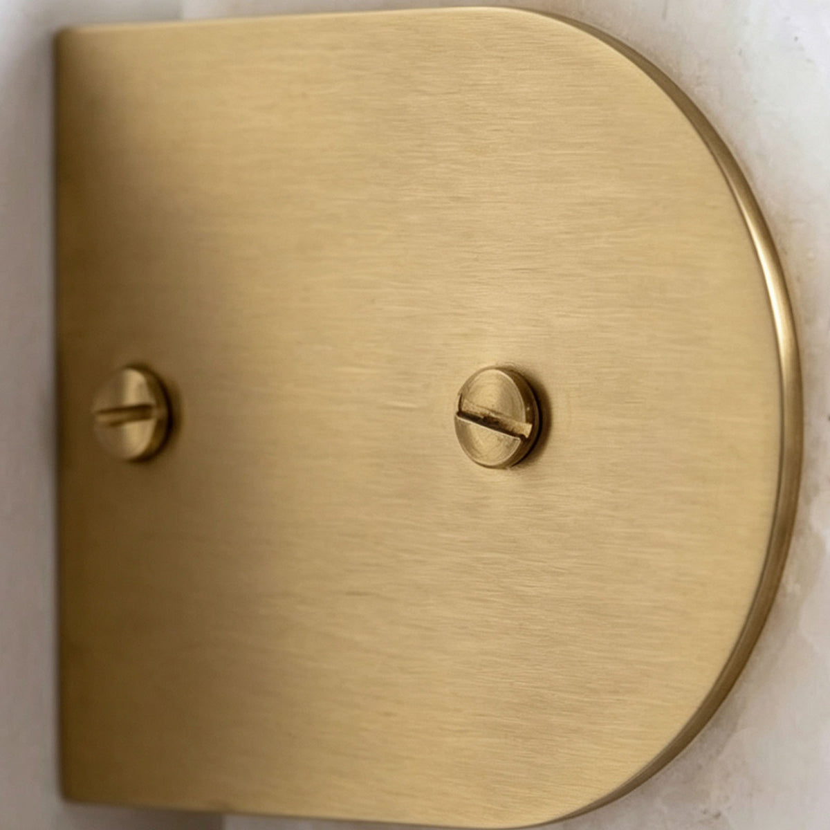Lamelune Stacked Sconce | Solid Brushed Brass | Close-up of arched brass end cap with dual slotted screws | Severn Lighting