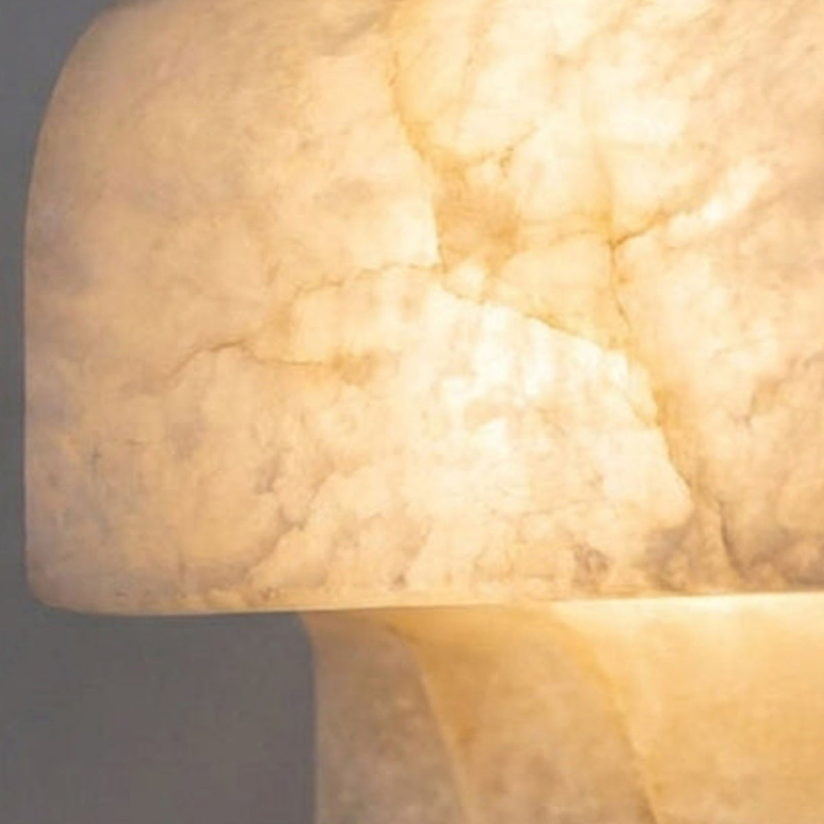 Lamelune Stacked Sconce | Translucent Alabaster | Macro lit close-up of warm glow diffusing through stone | Severn Lighting