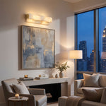Lamelune Stacked Sconce | Alabaster and Brass | Picture light mounted above canvas painting in living room | Severn Lighting