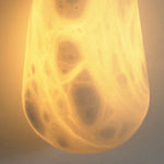 Larmelle Teardrop Sconce | Translucent Alabaster | Macro lit close-up of organic mineral veining and glow | Severn Lighting