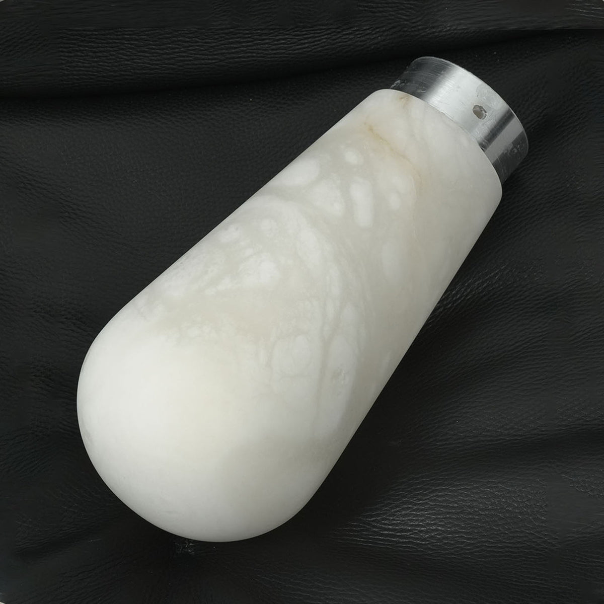 Larmelle Teardrop Sconce | Solid Alabaster | Single unlit teardrop stone shade on dark background | Severn Lighting