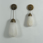 Larmelle Teardrop Sconce | Alabaster and Brass | Duo of two sizes hanging unlit on white wall | Severn Lighting