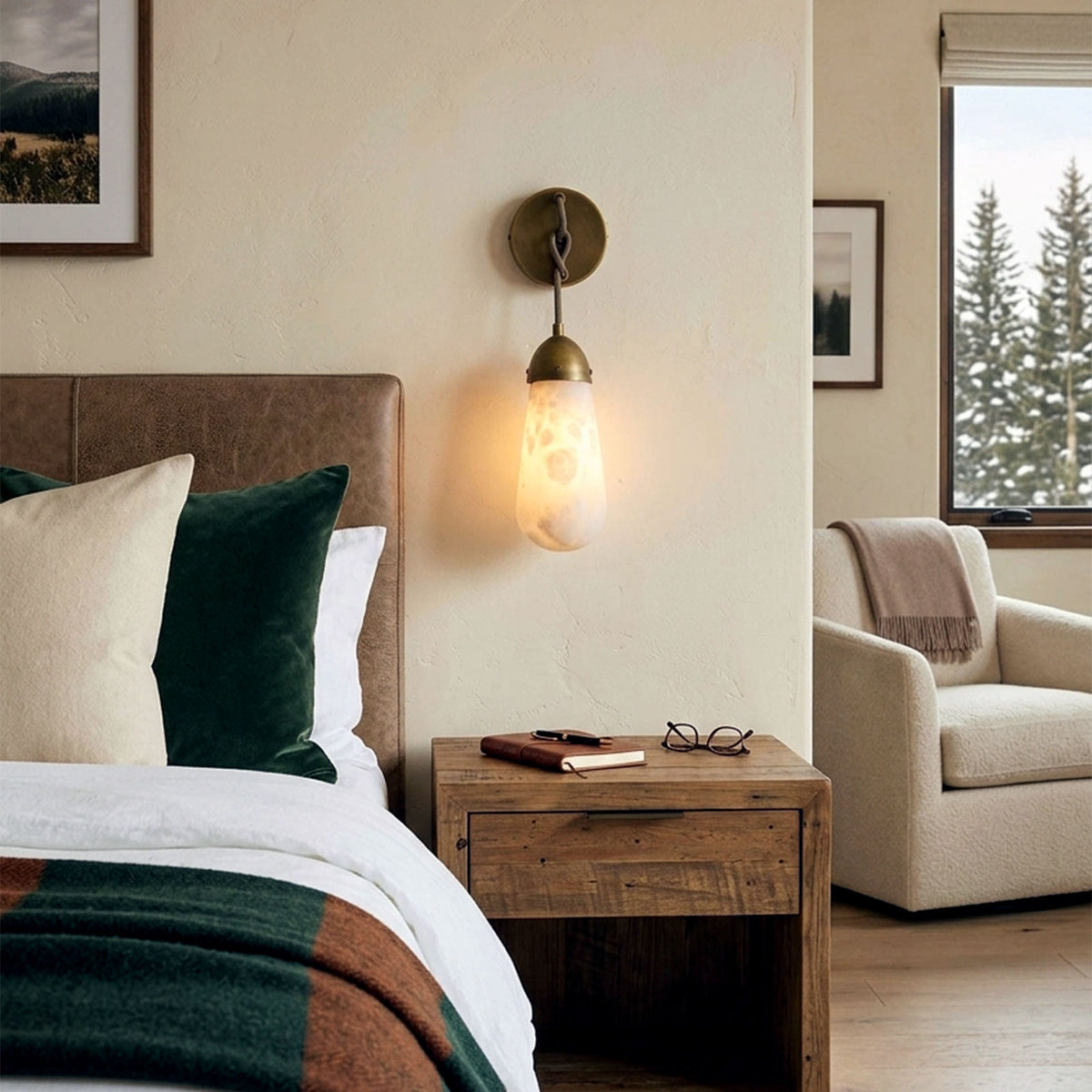 Larmelle Teardrop Sconce | Alabaster and Brass | Bedside accent lighting above wooden nightstand | Severn Lighting