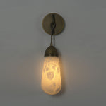 Larmelle Teardrop Sconce | Alabaster and Brass | Full unlit view against dark wall highlighting veins | Severn Lighting