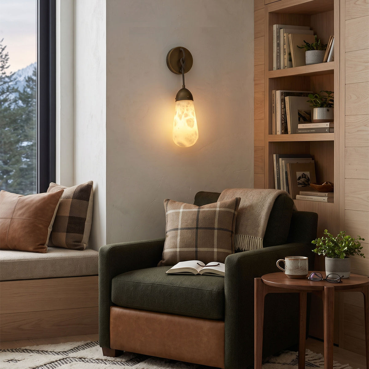 Larmelle Teardrop Sconce | Alabaster and Brass | Mounted in a cozy reading corner beside an armchair | Severn Lighting