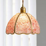 Liora Mosaic Glass Pendant Light | Pink Mosaic Glass and Brass | Standard studio shot of the illuminated pink mosaic shade hanging in front of a light backdrop | Severn Lighting