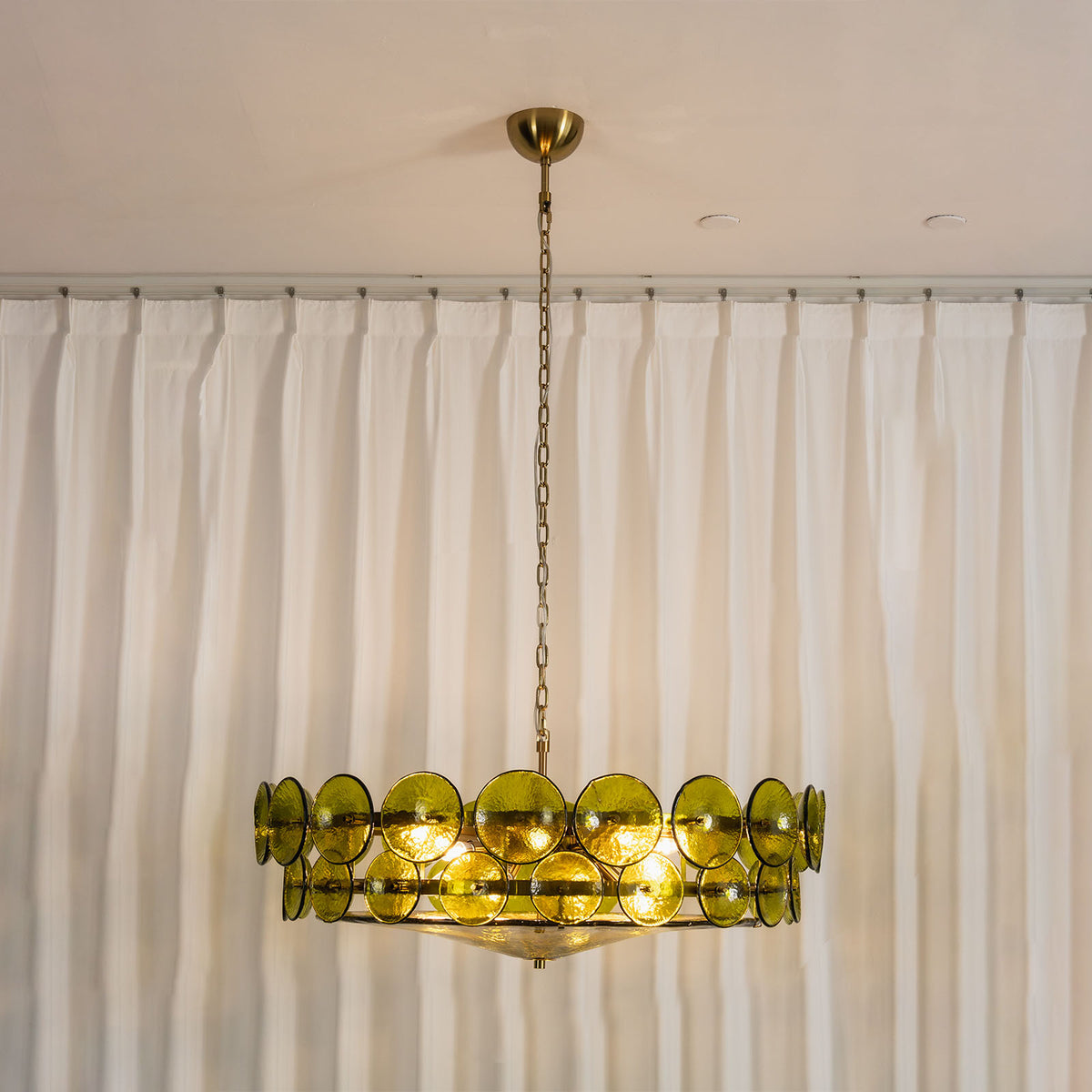 Lovenne Textured Glass Disc Ring Chandelier | Textured Glass and Brass | Full product view of illuminated green glass chandelier on a neutral background | Severn Lighting