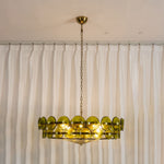 Lovenne Textured Glass Disc Ring Chandelier | Textured Glass and Brass | Full product view of illuminated green glass chandelier on a neutral background | Severn Lighting