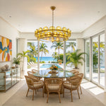 Lovenne Textured Glass Disc Ring Chandelier | Textured Glass and Brass | Green variant hanging over a round glass-top dining table near large windows | Severn Lighting
