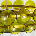 Lovenne Textured Glass Disc Ring Chandelier | Textured Glass and Brass | Macro close-up shot highlighting the dimpled texture of the green glass disc | Severn Lighting
