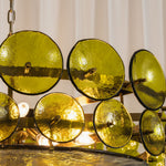 Lovenne Textured Glass Disc Ring Chandelier | Textured Glass and Brass | Side close-up view of green glass discs aligned on the brass circular frame | Severn Lighting
