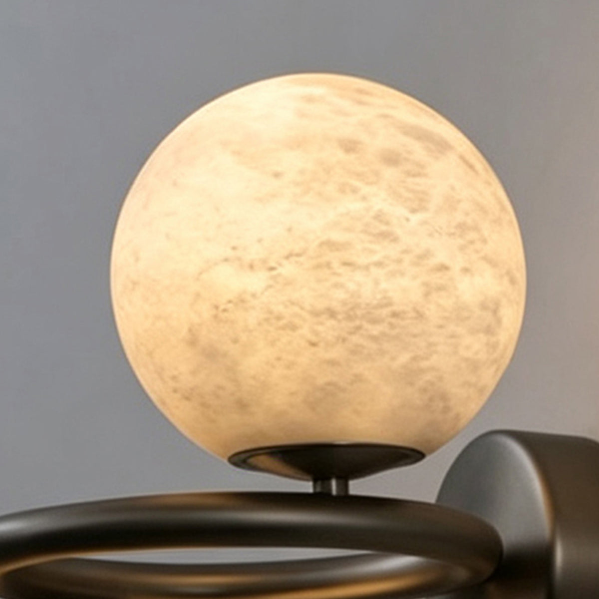 Lucern Twin Globe Alabaster Wall Sconce | Natural Alabaster and Matte Black Metal | Macro detail shot of the top spherical stone globe highlighting its organic earthy textures | Severn Lighting