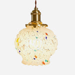 Marlowe Speckled Glass Pendant Lamp | Colorful Speckled Glass and Brass | Isolated studio front shot on a white background showing the lit textured glass shade with colorful specks | Severn Lighting