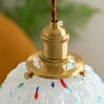 Marlowe Speckled Glass Pendant Lamp | Colorful Speckled Glass and Brass | Detailed close-up of the gold brass socket and cord connection atop the textured glass shade | Severn Lighting
