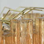 Merlande Amber Glass Tube Tiered Chandelier | Fluted Amber Glass and Brass | Macro close-up shot of brass mounting hooks holding amber glass tubes | Severn Lighting
