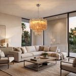 Merlande Amber Glass Tube Tiered Chandelier | Fluted Amber Glass and Brass | Centered in a contemporary living room with L-shaped sectional couch and view doors | Severn Lighting