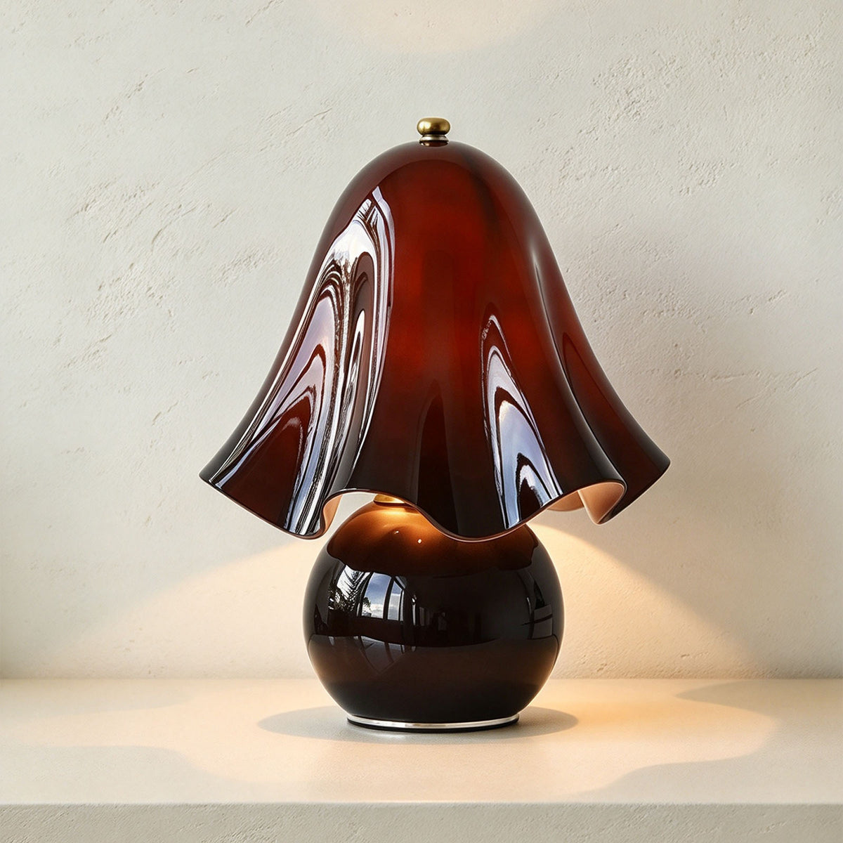 Mouchelle Mushroom Lamp | Wine Red Glass | Front illuminated view on console table against wall | Severn Lighting