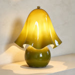 Mouchelle Mushroom Lamp | Olive Art Glass | Front illuminated view on tabletop against grey wall | Severn Lighting