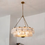 Nyle Tiered Glass Ring Chandelier | Textured Glass and Brass | Vertical full view of the chandelier hanging in a bright interior space | Severn Lighting