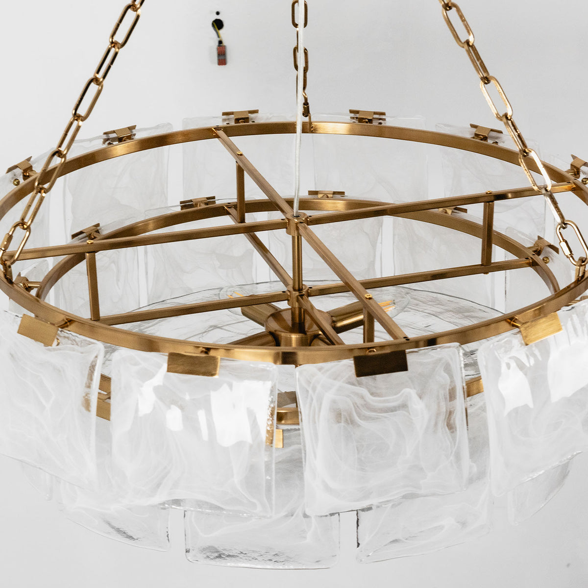 Nyle Tiered Glass Ring Chandelier | Textured Glass and Brass | Studio shot showing the internal brass frame structure without glass | Severn Lighting