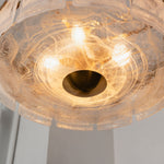 Nyle Tiered Glass Ring Chandelier | Textured Glass and Brass | Bottom-up perspective shot showing illuminated glass diffuser and bulbs | Severn Lighting
