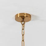 Nyle Tiered Glass Ring Chandelier | Textured Glass and Brass | Close-up view of the brass ceiling canopy and hanging chain hardware | Severn Lighting