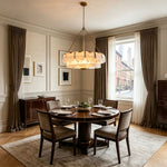 Nyle Tiered Glass Ring Chandelier | Textured Glass and Brass | Real-life installation view above a round wooden dining table | Severn Lighting