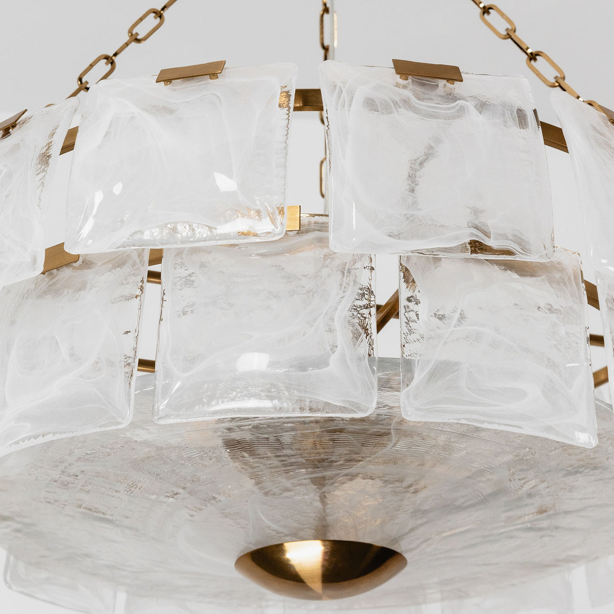 Nyle Tiered Glass Ring Chandelier | Textured Glass and Brass | Studio product shot on a pure white background showing tiered rings | Severn Lighting