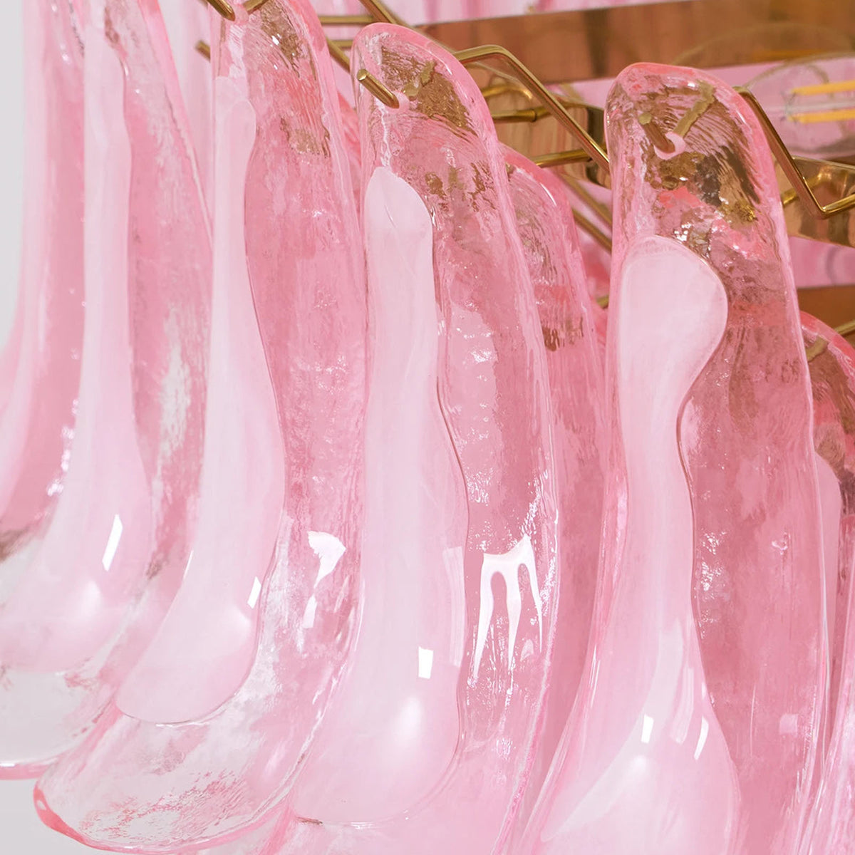 Ombeline Tiered Pink Glass Chandelier | Pink Glass and Brass | Macro shot highlighting the translucent pink glass petal shapes | Severn Lighting