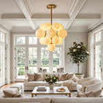 Ottoline Alabaster Cluster Chandelier | Natural Alabaster and Brass | Illuminating a spacious contemporary living room featuring a white sofa and a coffered ceiling | Severn Lighting