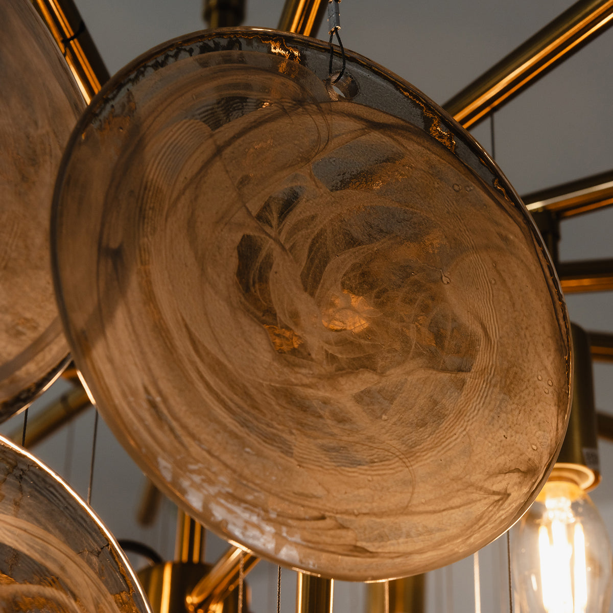 Perrin Smoked Glass Cloud Chandelier | Smoked Glass and Brass | Bottom-up perspective highlighting warm glowing glass textures | Severn Lighting