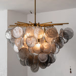 Perrin Smoked Glass Cloud Chandelier | Smoked Glass and Brass | Real-life installation view glowing softly against a plain wall | Severn Lighting