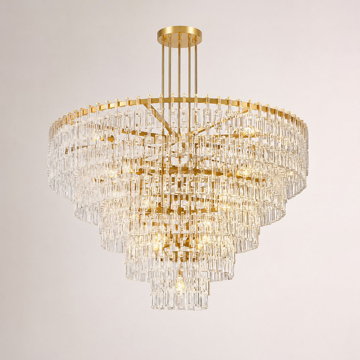 Rainer Cascading Glass Rod Chandelier | Clear Glass and Brass | Brass frame option illuminated on a plain white background | Severn Lighting