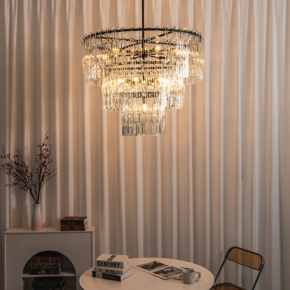 Rainer Cascading Glass Rod Chandelier | Clear Glass and Black Metal | Ambient lighting shot hanging against vertical fluted wall panel | Severn Lighting