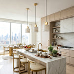 Sabine Alabaster Drum Pendant Light | Natural Alabaster and Brass | Three fixtures suspended above a light marble kitchen counter with wooden stools and chic cabinets | Severn Lighting