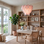 Seraphina Rose Glass Petal Chandelier | Glass, Metal | Providing a warm pinkish glow in an elegant home office workspace with a wooden desk, rattan chair, and large built-in bookshelf | Severn Lighting