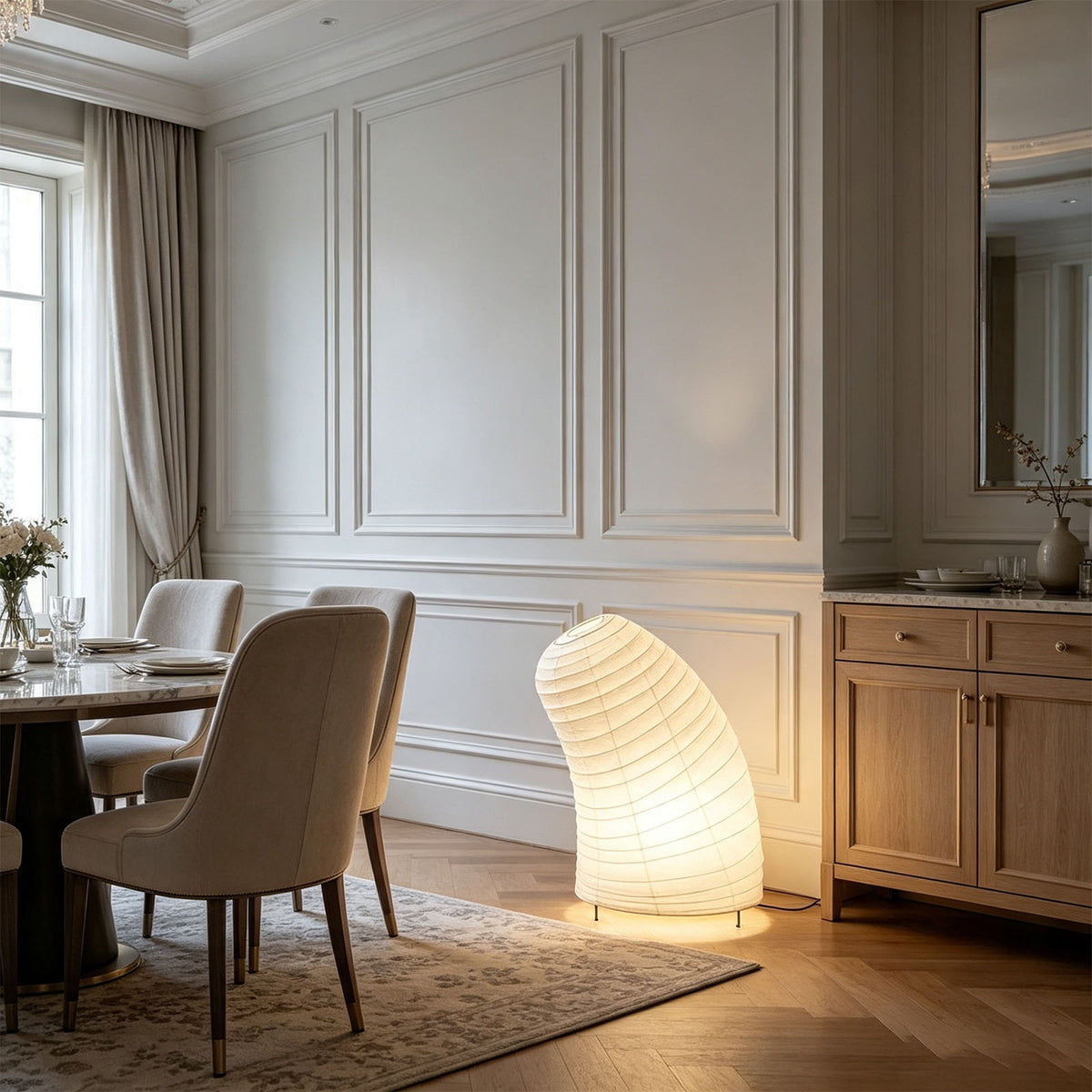 Severine Spiral Washi Paper Table Lamp | Washi Paper and Metal | Glowing warmly on the floor in an elegant dining room | Severn Lighting
