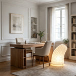 Severine Spiral Washi Paper Table Lamp | Washi Paper and Metal | Displayed on the floor in a home office space near a wooden desk | Severn Lighting