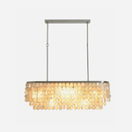 Sirena Capiz Elongated Linear Chandelier | Capiz Shell, Metal | Elongated rectangular linear chandelier with overlapping translucent capiz shell discs and chrome suspension rods | Isolated lit product shot on white background | Samu Lamp