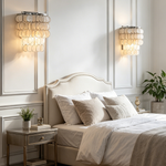 Sirena Capiz Tiered Wall Sconce | Capiz Shell, Metal | Symmetrically installed as elegant bedside sconces on a white paneled wall in a classic bedroom | Samu Lamp