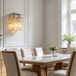 Sirena Capiz Tiered Wall Sconce | Capiz Shell, Metal | Mounted as sophisticated accent lighting on a classic dining room wall near a long dining table | Samu Lamp