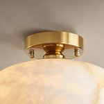 Solaine Alabaster Dome Ceiling Light | Natural Alabaster and Brass | Close-up view of the brushed brass canopy and mounting hardware | Severn Lighting