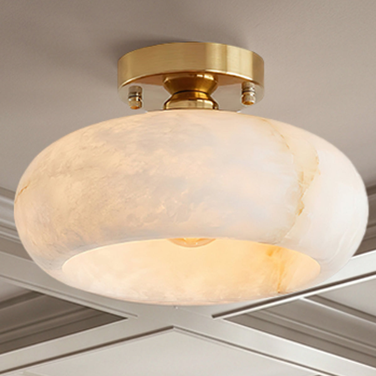 Solaine Alabaster Dome Ceiling Light | Natural Alabaster and Brass | Low-angle perspective view showcasing the glowing stone shade | Severn Lighting