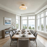 Solaine Alabaster Dome Ceiling Light | Natural Alabaster and Brass | Illuminating an elegant dining room with a long wooden table | Severn Lighting