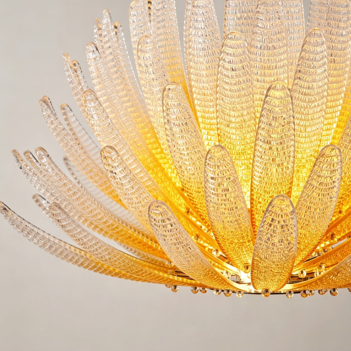 Solaris Agave Glass Starburst Chandelier | Amber Textured Glass | Detailed side view highlighting the layered organic arrangement of the glowing agave leaves | Severn Lighting