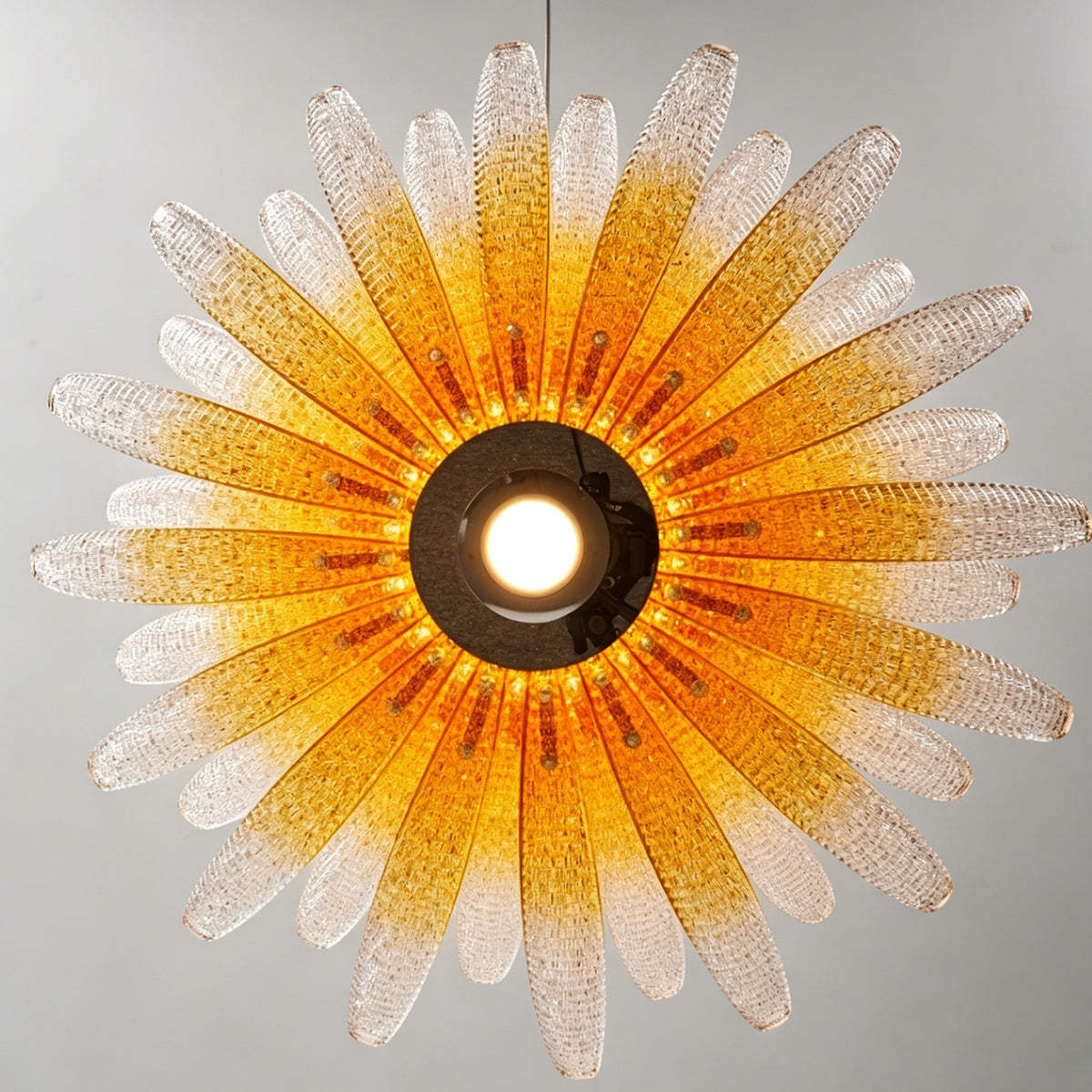 Solaris Agave Glass Starburst Chandelier | Amber Textured Glass | Directly underneath view showcasing the glowing starburst pattern of the amber glass leaves | Severn Lighting