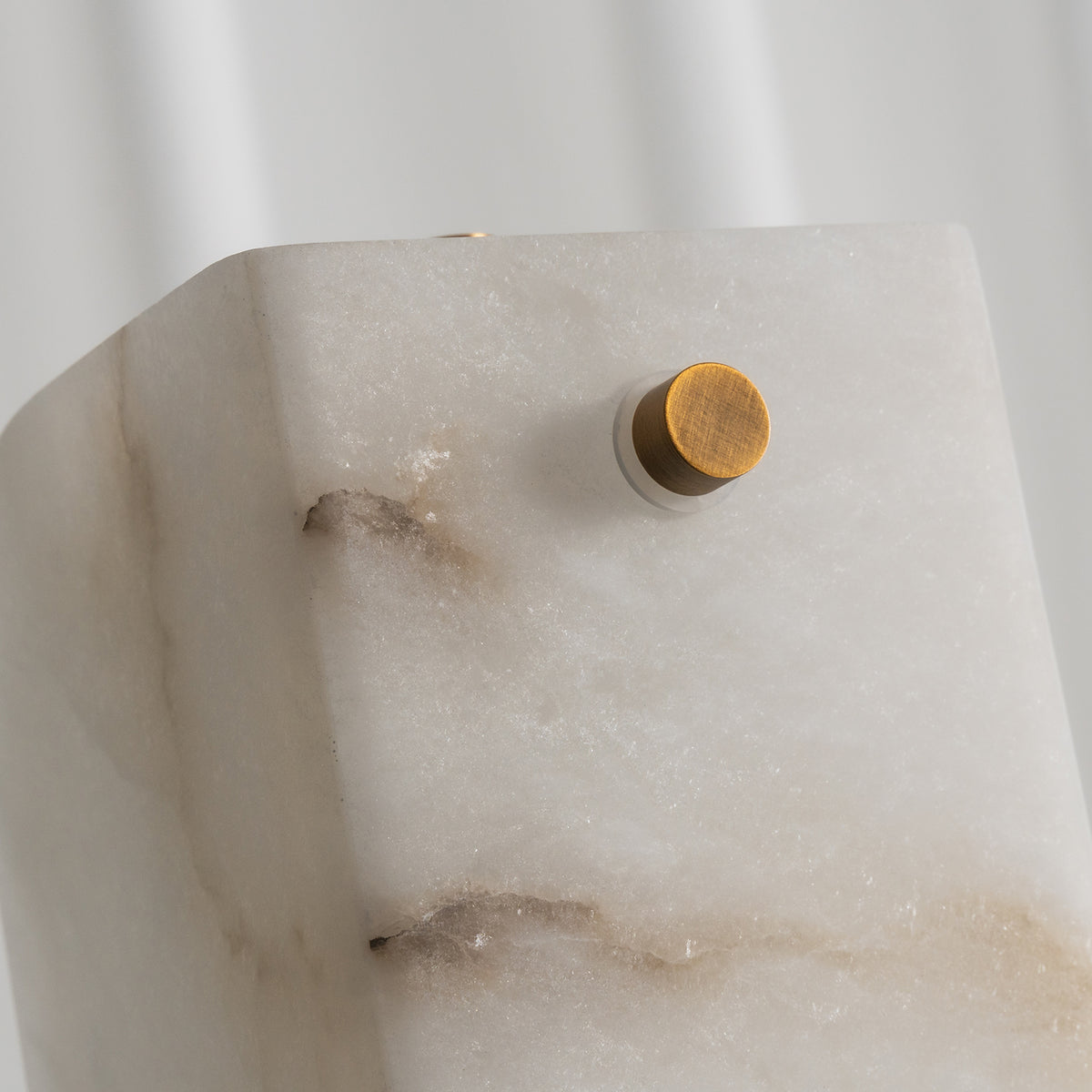 Stellan Alabaster Column Floor Lamp | Natural Alabaster, Brass and Black Metal | Detail view of the top alabaster stone slab edge and brass pin | Severn Lighting