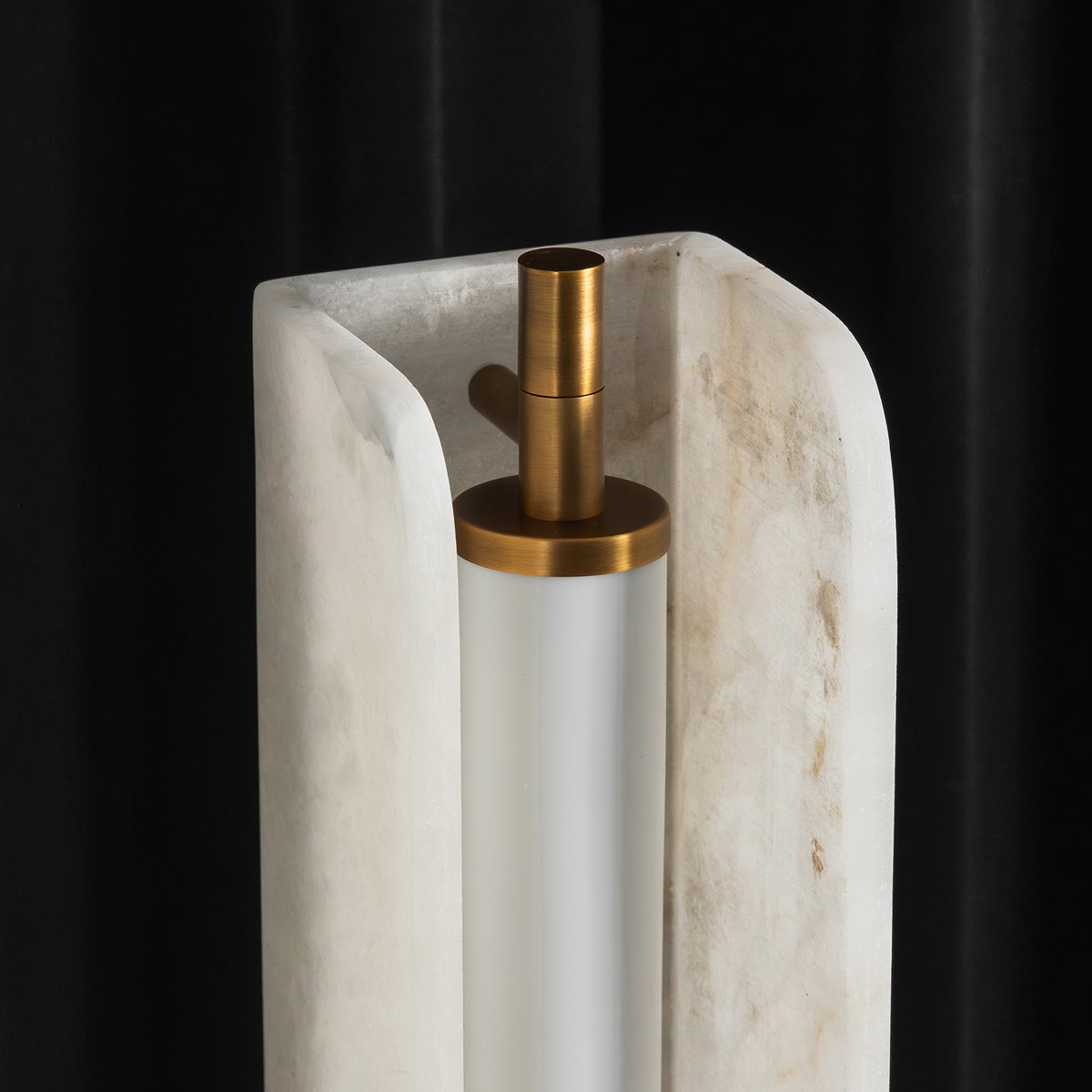 Stellan Alabaster Column Floor Lamp | Natural Alabaster, Brass and Black Metal | Detail shot showing the inner brass structure against dark backdrop | Severn Lighting